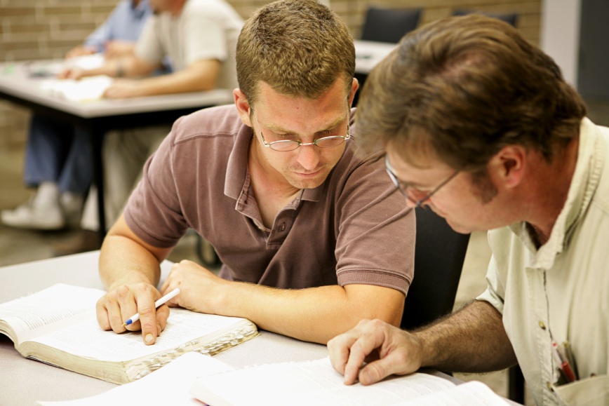 Two adult education students studying together in class.